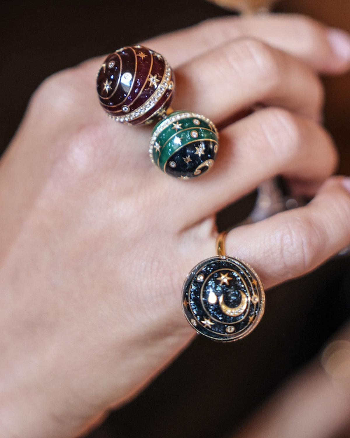 Bubble Circle I rings worn together on the hand — 18k gold sphere rings with aubergine, green and grey grand feu enamel and pavé diamonds, by Sandrine Barabinot