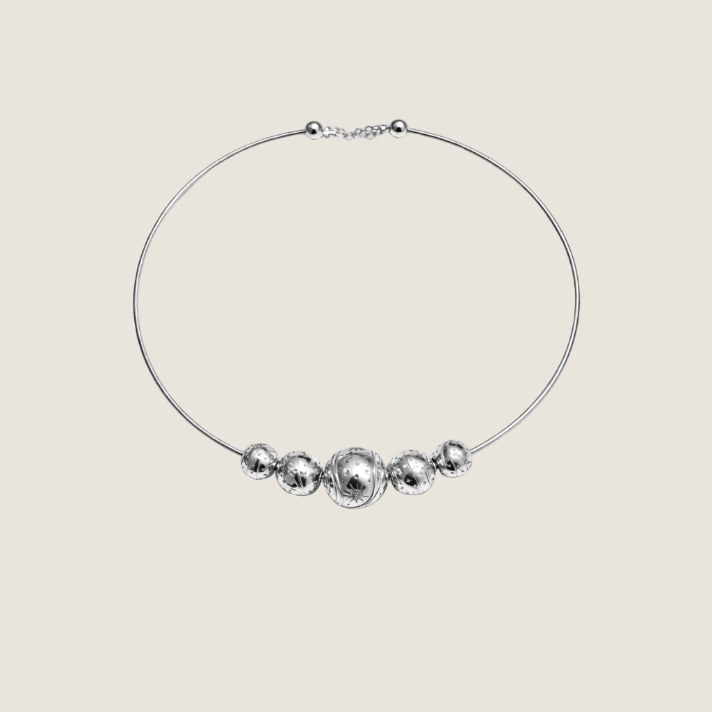 Kindred — Sandrine Barabinot rhodium-plated silver torque necklace with three graduated engraved Bubble spheres and white sapphires