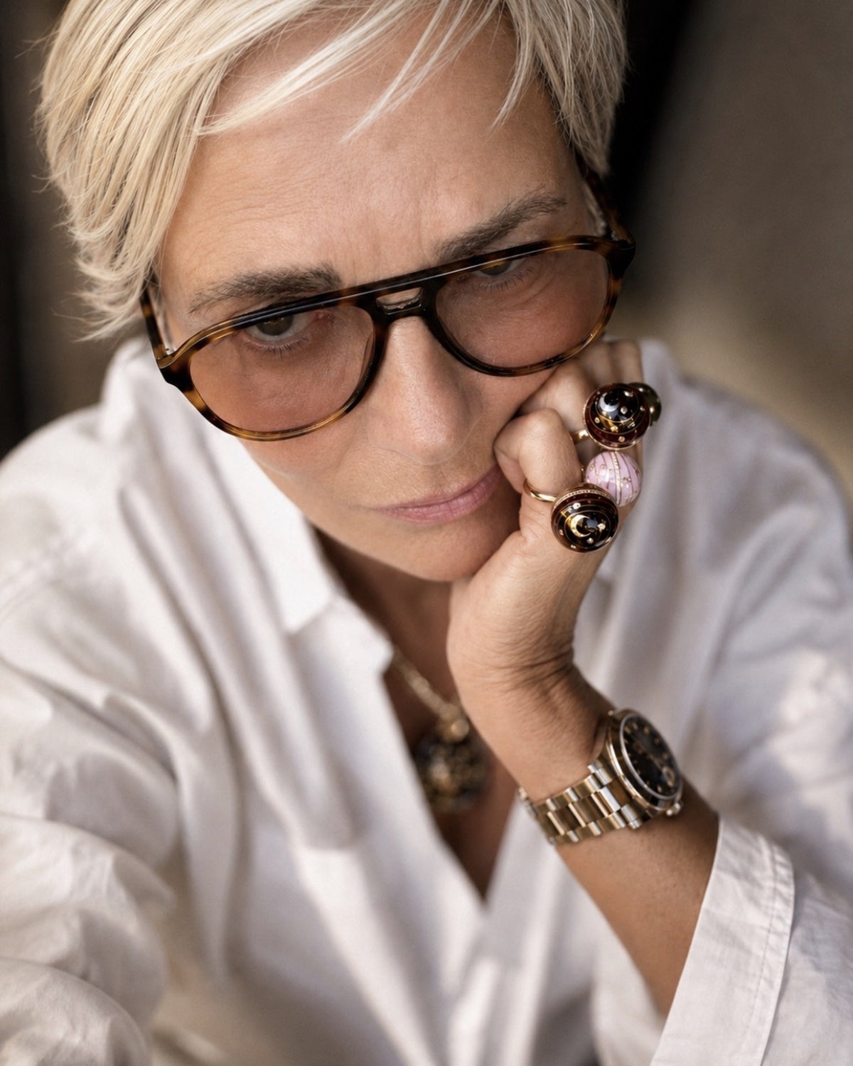 Sandrine Barabinot, founder of the Maison, wearing three Bubble Circle rings in 18k gold and grand feu enamel