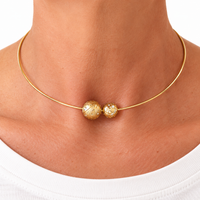 Torque Double Take necklace worn, two 18k gold Bubble spheres with diamonds on a rigid torque — Sandrine Barabinot